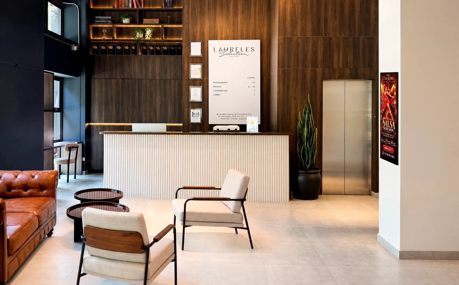 Lobby de Laureles Selection Suites con la pantalla publicitaria en la pared